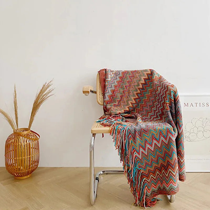 Jeté bohème en tricot à motif géométrique avec pompons